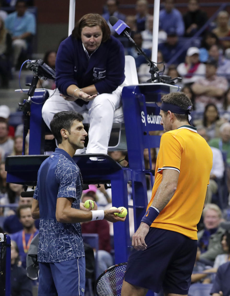 Novak Djokovic, of Serbia, left, talks with Juan Martin del Potro, of Argentina, as chair umpire Alison Hughes listens during the men's final of the U.S. Open tennis tournament, Sunday, Sept. 9, 2018, in New York. (AP Photo/Julio Cortez)