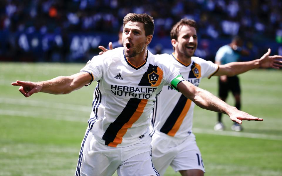 Steven Gerrard, left, celebrates his LA Galaxy goal with Mike Magee during a 2016 MLS game against the New England Revolution in Carson, Calif.