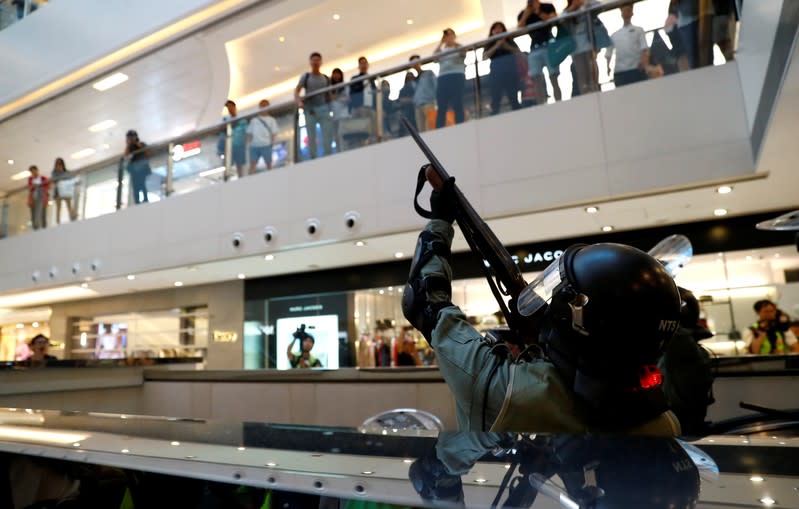 Shoppers and anti-government protesters gather at New Town Plaza in Sha Tin, Hong Kong