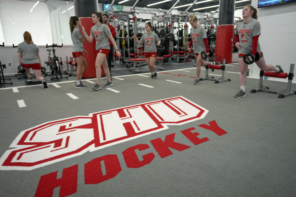 Members of the women's hockey team exercise in the weight room of the newly constructed NCAA college hockey Martire Family Arena on the campus of Sacred Heart University in Fairfield, Conn., Monday, Jan 9, 2023. (AP Photo/Bryan Woolston)