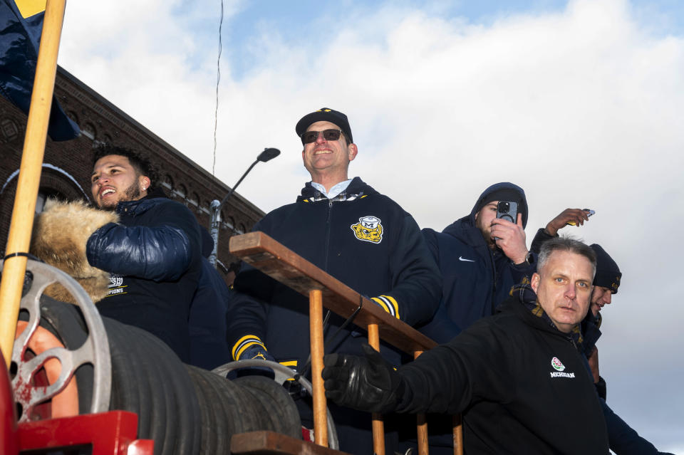 Michigan running back Blake Corum, coach Jim Harbaugh and offensive lineman Zak Zinter take part in a parade celebrating Michigan's college football title, in Ann Arbor, Mich., Saturday, Jan. 13, 2024. (Jacob Hamilton/Ann Arbor News via AP)