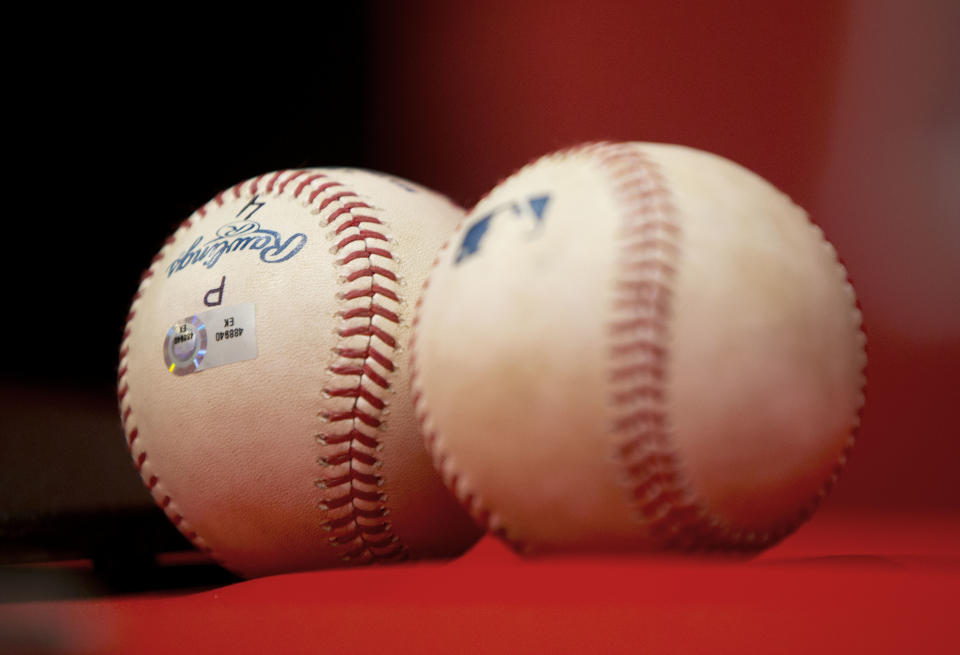 Los Angeles Angels Albert Pujols' 500th, left, and 499th, right, career home run baseballs are seen on the table during a news conference following a baseball game against the Washington Nationals, Tuesday, April 22, 2014 in Washington. Angels won the game 7-2. (AP Photo/Pablo Martinez Monsivais)