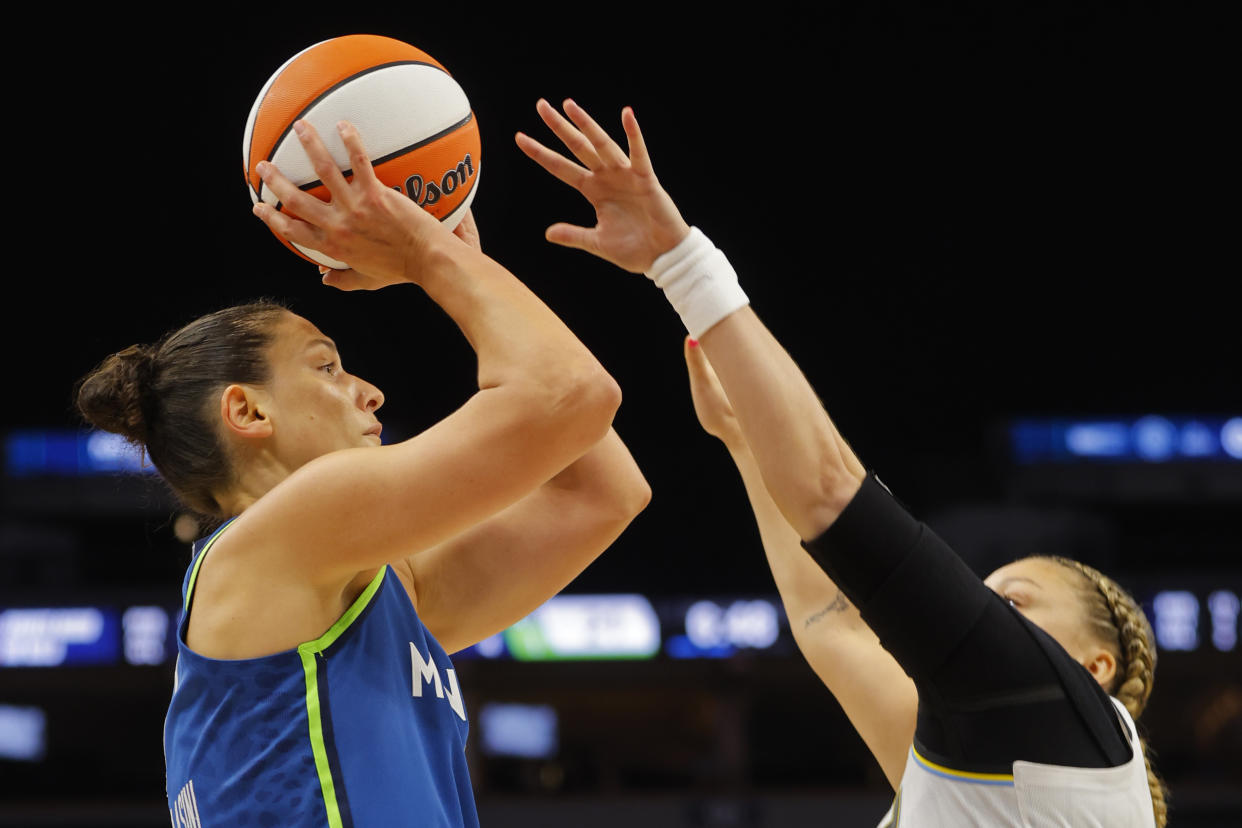 Minnesota Lynx forward Cecilia Zandalasini, left, shoots over Chicago Sky guard Rachel Banham, right, in the second quarter of a WNBA basketball game Friday, Sept. 13, 2024, in Minneapolis. (AP Photo/Bruce Kluckhohn)