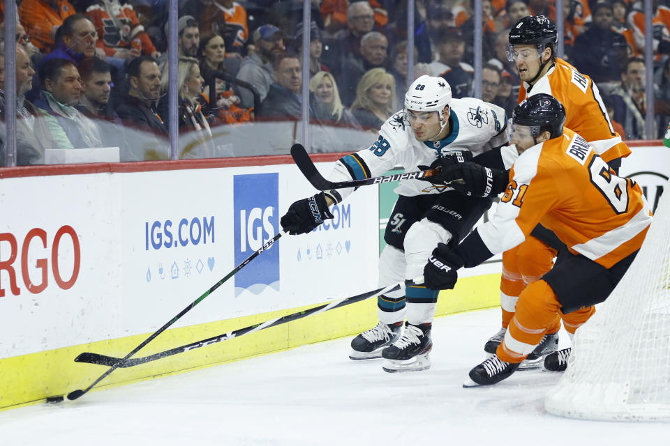 San Jose Sharks' Timo Meier (28) tries to keep the puck away from Philadelphia Flyers' Justin Braun (61) and Robert Hagg (8) during the first period of an NHL hockey game, Tuesday, Feb. 25, 2020, in Philadelphia. (AP Photo/Matt Slocum)