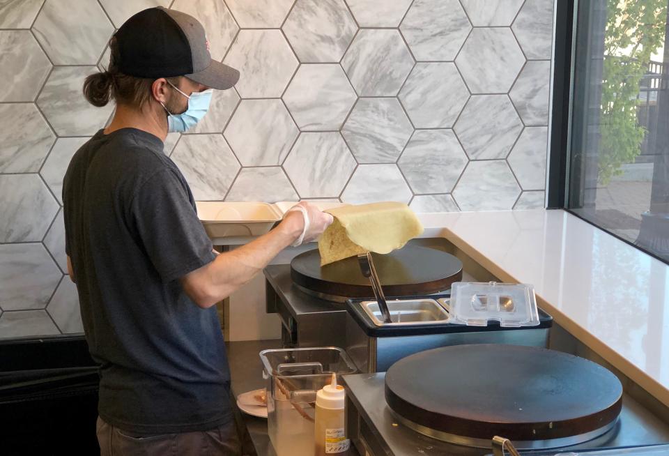 Jonathan Delo with Kitchern Zero prepares a crêpe for a customer Tuesday, May 11, on the first day of business for the restaurant.
