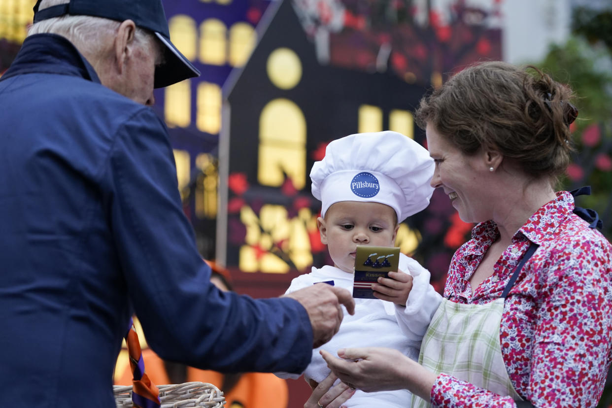 President Joe Biden and first lady Jill Biden give treats to trick-or-treaters on the South Lawn of the White House, on Halloween, Monday, Oct. 31, 2022, in Washington. (AP Photo/Alex Brandon)