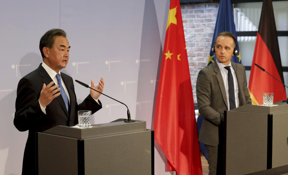 German Foreign Minister Heiko Maas, right, and China's Foreign Minister Wang Yi, left, address the media during a joint press conference as part of a meeting in Berlin, Germany, Tuesday, Sept. 1, 2020. (AP Photo/Michael Sohn, pool)