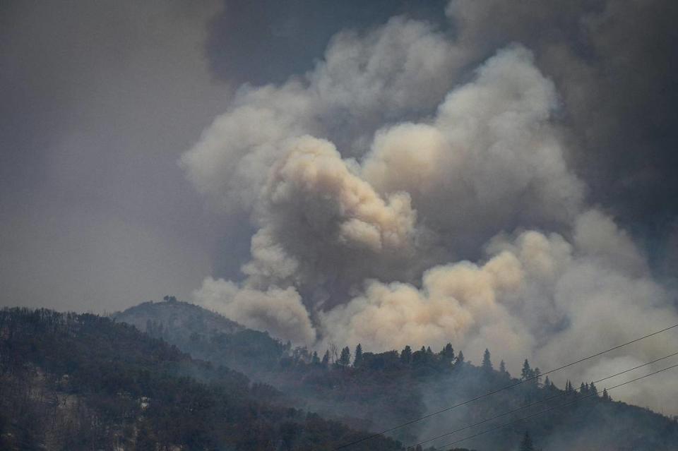 Smoke billows from a mountainside east of Mariposa as the Oak Fire rages on Saturday, July 23, 2022.