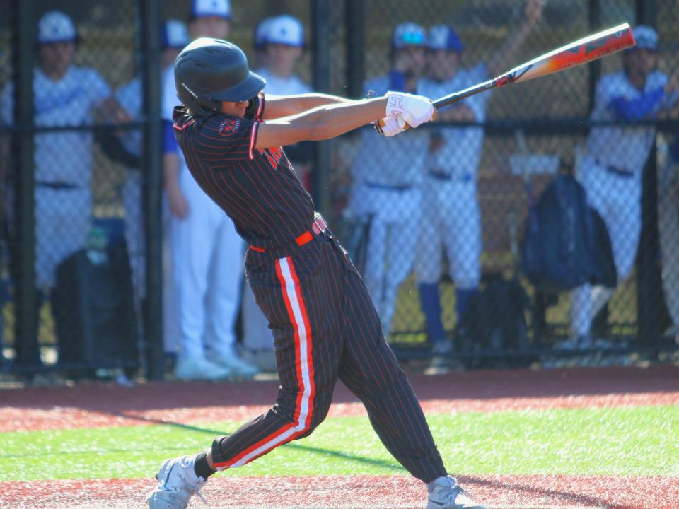 Taunton's Dwayne Burgo hits a single during a Hockomock League game against Attleboro.