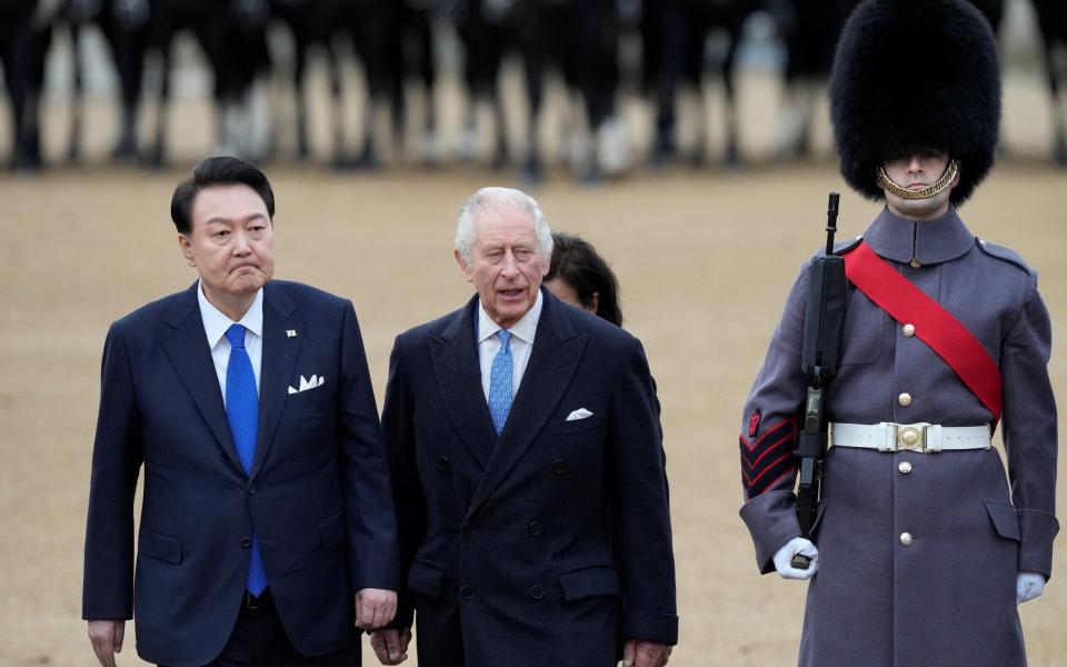 The King escorts the President of South Korea Yoon Suk Yeol after inspecting the Guard of Honour at Horse Guards Parade