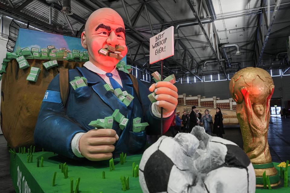 A carnival float depicts FIFA President Gianni Infantino with dollar notes in his mouth at the presentation of this years satirical carnival floats for the Rose Monday Parade in Cologne, Germany, Tuesday, Feb. 14, 2023. Hundreds of thousands will celebrate the traditional parade the streets of Germany's carnival capital next week on Shrove Monday. (AP Photo/Martin Meissner)
