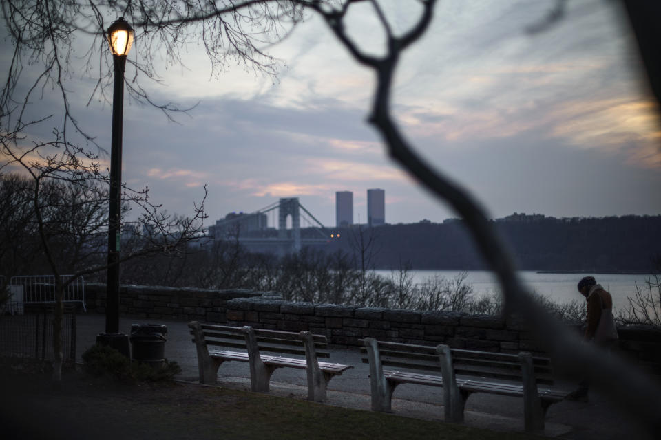 An empty bench overlooks the Hudson River where Fernando Morales used to sit and eat tuna sandwiches with his younger brother, Adam Almonte, in Fort Tryon Park in New York, Wednesday, March 16, 2022. On the deadliest day of a horrific week in April 2020, COVID-19 took the lives of 816 people in New York City alone. Morales, 43, was one of them. Walking through the park, Almonte visualizes long-ago days tossing a baseball with his brother and taking in the view from their bench with sandwiches in hand. He replays old messages to just to hear Morales' voice. "When he passed away it was like I lost a brother, a parent and a friend all at the same time," says Almonte. "That's an irreplaceable type of love." (AP Photo/David Goldman)