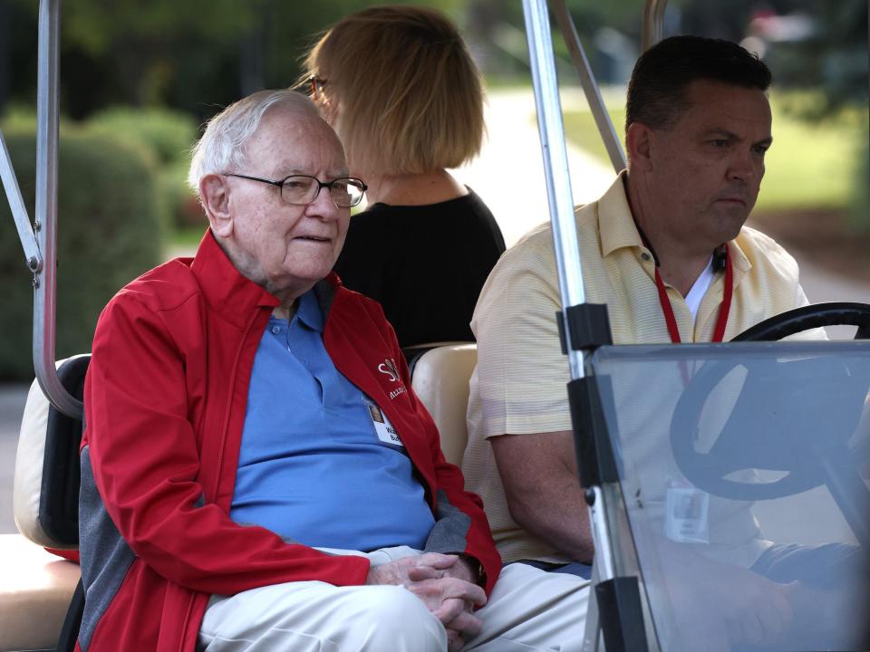 Warren Buffett rides a golf cart at Sun Valley