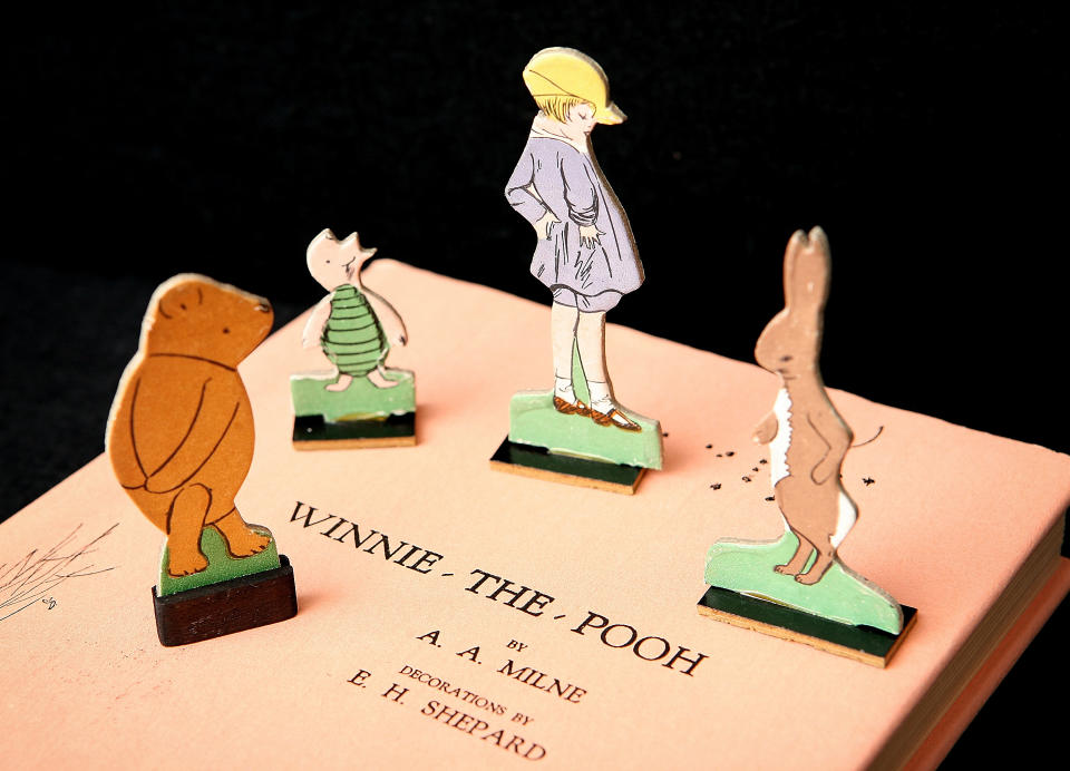 LONDON - DECEMBER 15:  A rare American first edition of a Winnie-the-Pooh book signed by the author A.A. Milne and illustrator E.H Shephard is displayed with Pooh characters form a 1930's game at a press preview at Sotheby's Auctioneers on December 15, 2008 in London. Sotheby's is holding an auction of original artworks and rare first edition books featuring the famous characters by A.A. Milne from the private collections of Stanley J. Seeger and Christopher Cone on December 17, 2008.  (Photo by Peter Macdiarmid/Getty Images)