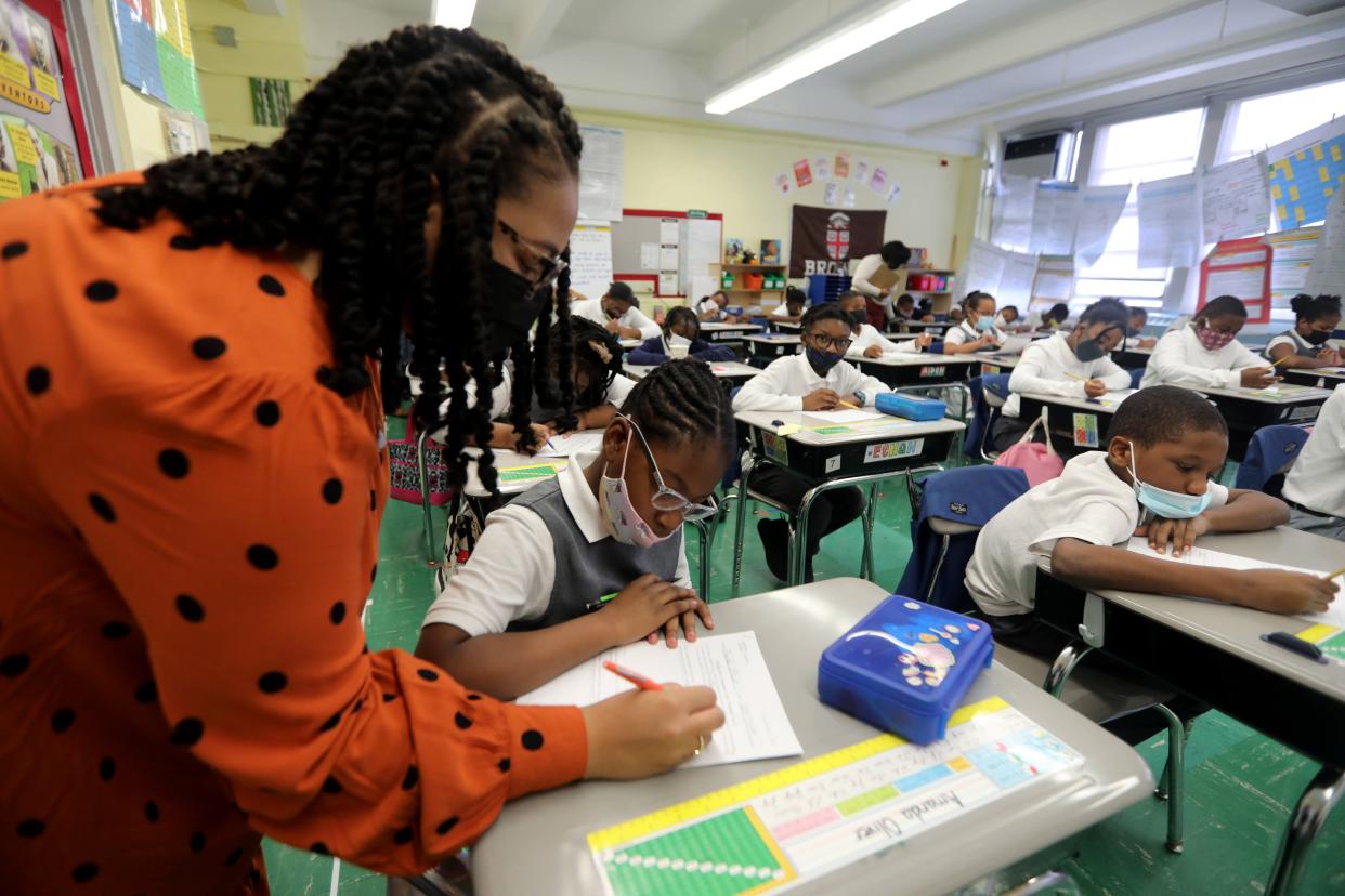 Azure Garrett, a fourth-grade teacher at Leadership Prep Canarsie, a charter school in Brooklyn, New York, works with student Amanda Oliver on Oct. 28, 2021.