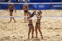 April Ross, left, of the United States, celebrate with teammate Alix Klineman a winning point during a women's beach volleyball match against Germany at the 2020 Summer Olympics, Tuesday, Aug. 3, 2021, in Tokyo, Japan. (AP Photo/Petros Giannakouris)