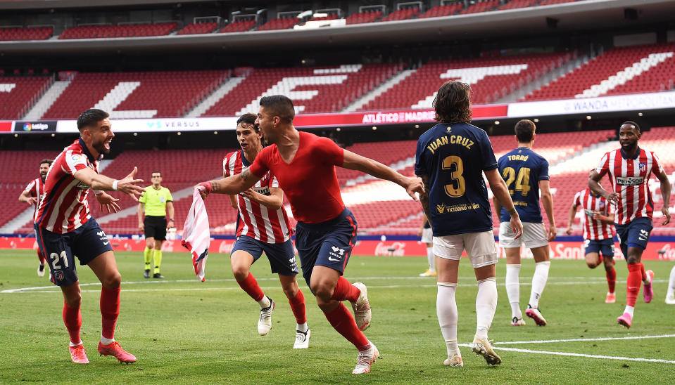 MADRID, SPAIN - MAY 16: Luis Suarez of Atletico Madrid celebrates after scoring their team's second goal with Yannick Ferreira Carrasco  during the La Liga Santander match between Atletico de Madrid and C.A. Osasuna at Estadio Wanda Metropolitano on May 16, 2021 in Madrid, Spain. Sporting stadiums around Spain remain under strict restrictions due to the Coronavirus Pandemic as Government social distancing laws prohibit fans inside venues resulting in games being played behind closed doors.  (Photo by Denis Doyle/Getty Images)