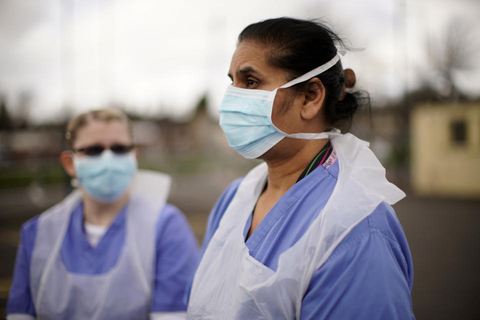 WOLVERHAMPTON, ENGLAND - MARCH 12: NHS nurses speak to the media as they wait for the next patient at a drive through Coronavirus testing site on March 12, 2020 in Wolverhampton, England. The National Health Service facility has been set up in a car park to allow people with NHS referrals to be swabbed for Covid-19. (Photo by Christopher Furlong/Getty Images)