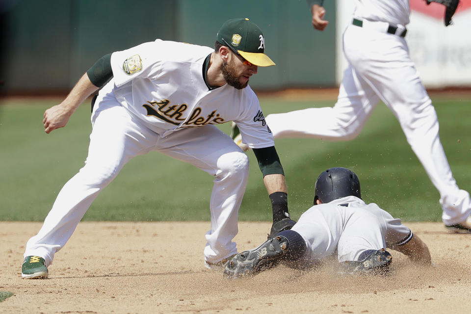 New York Yankees' Brett Gardner, right, is tagged out trying to steal second by Oakland Athletics second baseman Jed Lowrie during the fifth inning of a baseball game in Oakland, Calif., Monday, Sept. 3, 2018. (AP Photo/Jeff Chiu)