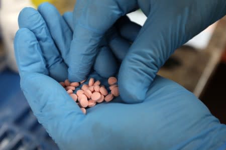 A pharmacist counts prescription drugs at the at the CentreTown Pharmacy in Ottawa