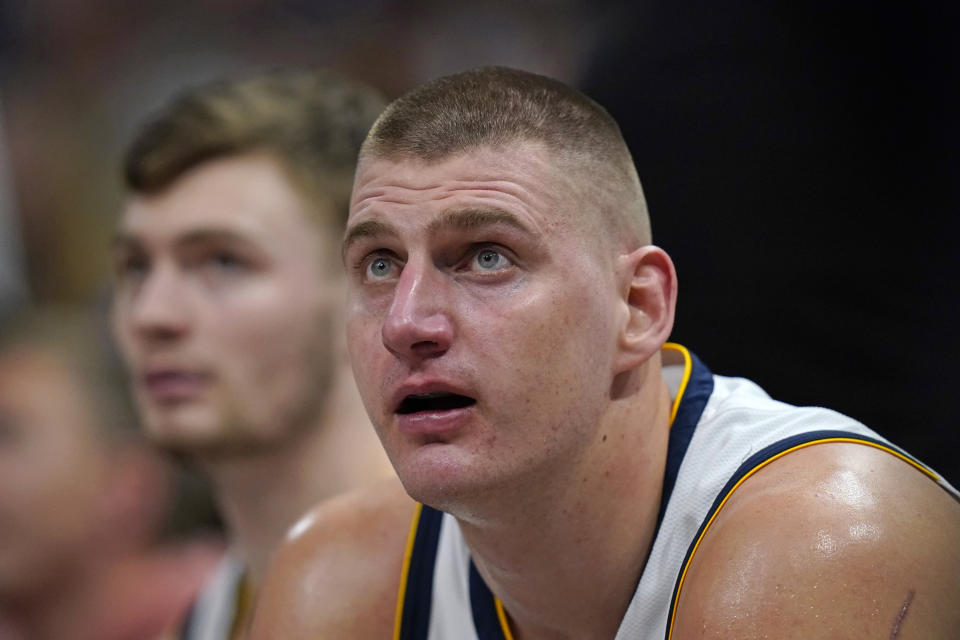 Denver Nuggets center Nikola Jokic looks sits on the bench during the second half of the team's NBA basketball game against the Utah Jazz on Wednesday, Jan. 10, 2024, in Salt Lake City. (AP Photo/Rick Bowmer)
