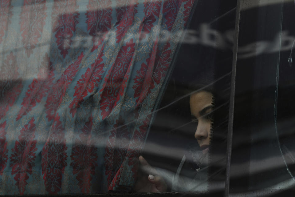 FILE - A migrant looks out the window on a bus on her way north to Nicaragua and hopefully to the Mexico-United States border, in Paso Canoas, Costa Rica, Oct. 16, 2023. Panama and Costa Rica launched a plan to quickly bus thousands of migrants through Panama to the Costa Rican border, as the countries continue to grapple with the increasing number of migrants. (AP Photo/Carlos Gonzalez, File)