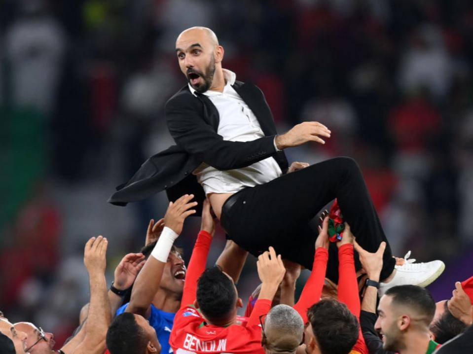 Hitting new heights: Walid Regragui celebrates with his Morocco players after their quarter-final win over Portugal (Getty)