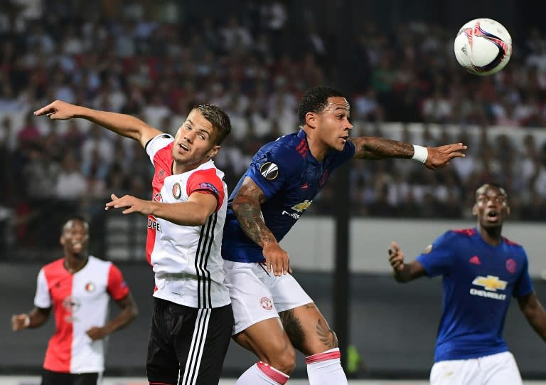 Manchester United's Dutch midfielder Memphis Depay (R) vies with Feyenoord's Bart Nieuwkoop during a UEFA Europa League football match in Rotterdam on September 15, 2016