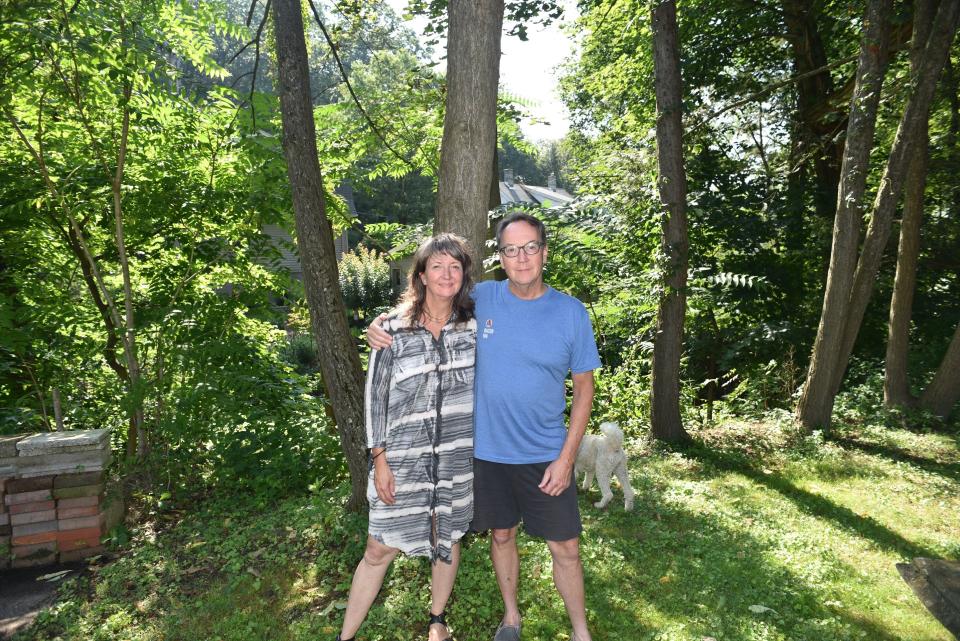 Janet Funk with her oldest brother Paul standing outside in a forest.