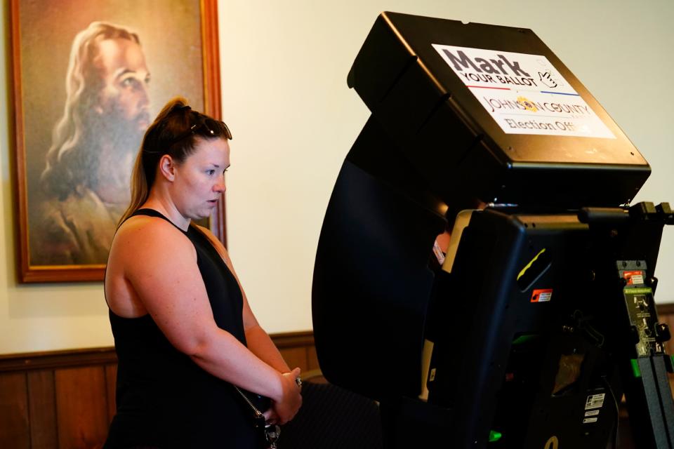 A poll worker helps a voter cast their ballot in the Kansas primary election on Aug. 2, 2022. Kansas was the first state to weigh in on abortion following the U.S. Supreme Court decision overturning Roe v. Wade. Voters upheld abortion rights 61% to 39%.