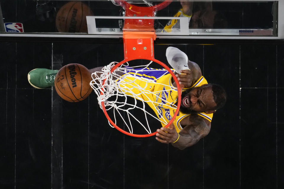 Los Angeles Lakers forward LeBron James (23) scores in the first half of an NBA basketball game against the Atlanta Hawks Tuesday, Jan. 30, 2024, in Atlanta. (AP Photo/John Bazemore)
