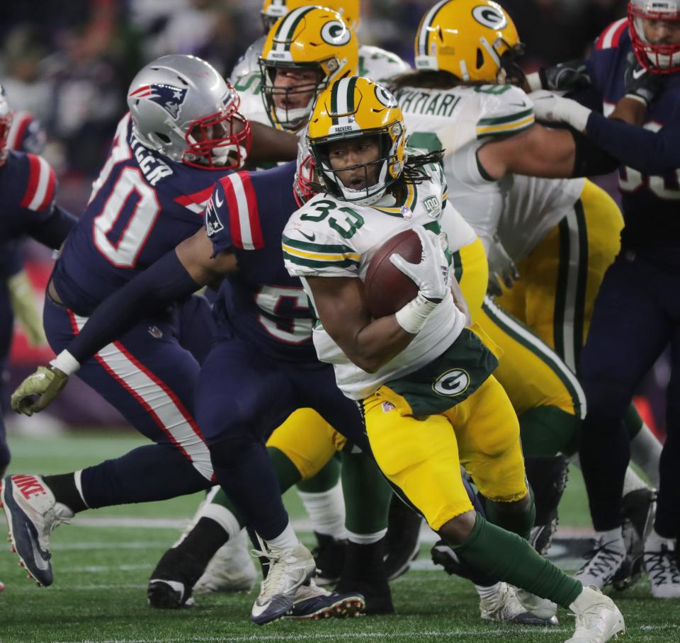 Green Bay Packers running back Aaron Jones (33) spins after getting stopped at the line of scrimmage during the second quarter of their game against the New England Patriots Sunday, November 4, 2018 at Gillette Stadium in Foxborough, Mass.