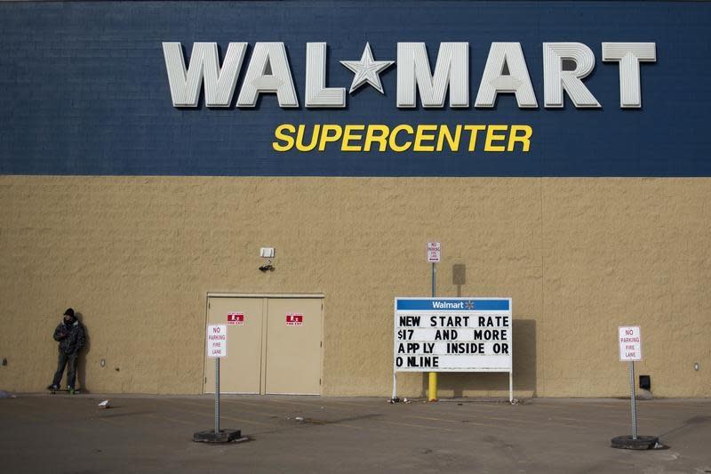 A man stands on a skateboard outside a Wal-Mart store in Williston, North Dakota March 13, 2013. REUTERS/Shannon Stapleton