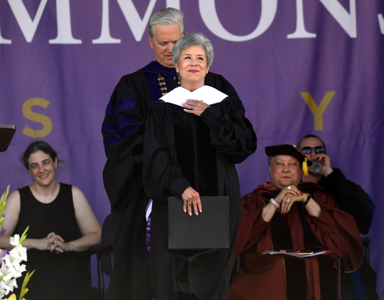 Former first lady of Hardin-Simmons University Carol Hall is hooded by current HSU President Eric Bruntmyer after conferring an honorary degree upon her during Friday's graduation ceremony. Hall's husband, Lanny, twice served as president of HSU. His wife was honored for her many activities related to the university and the community.