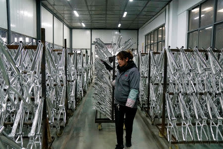 An employee works on the production line of Kent bicycles at Shanghai General Sports Co., Ltd, in Kunshan, Jiangsu Province, China, February 22, 2019. Picture taken February 22, 2019. REUTERS/Aly Song