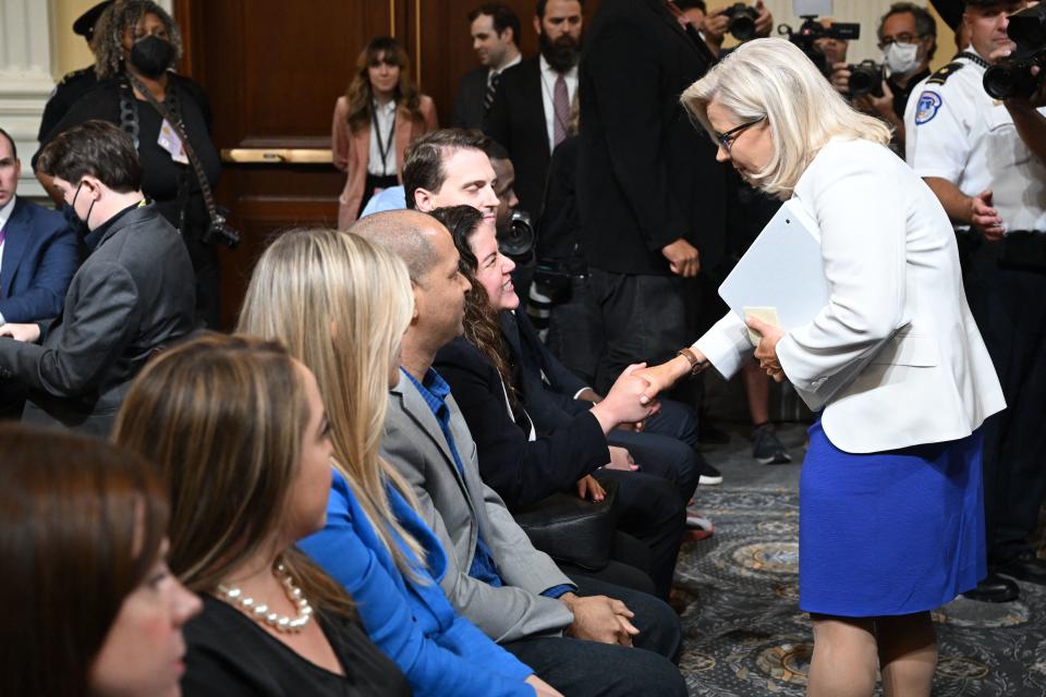 Rep. Liz Cheney shakes hands with Sandra Garza, the longtime partner of Capitol Police Officer Brian Sicknick.