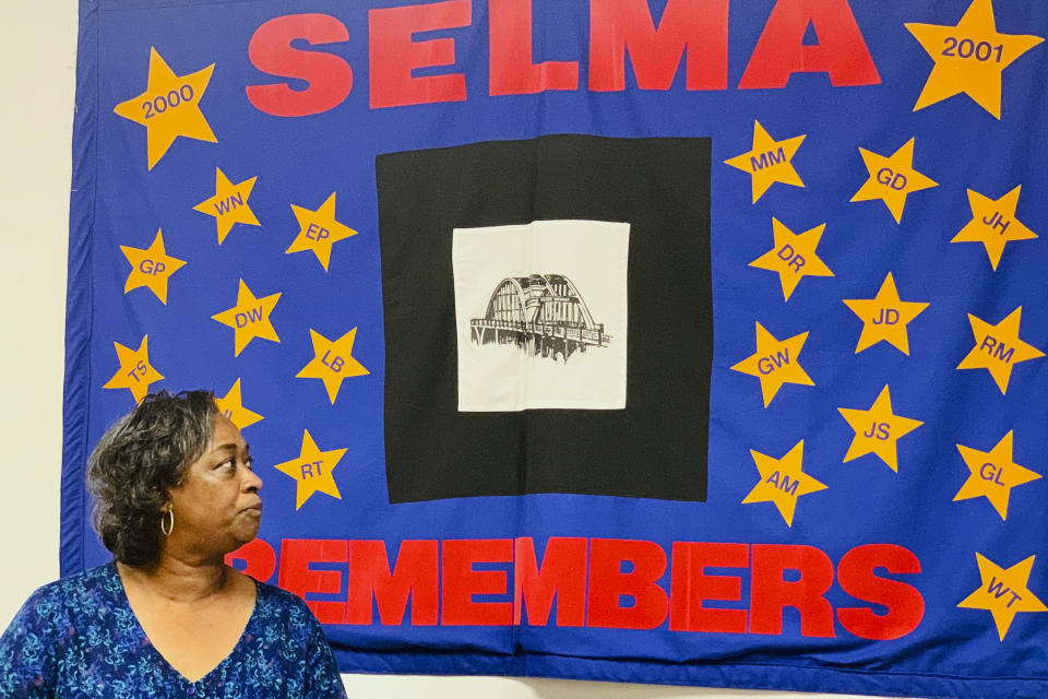 Mel Prince, executive director of Selma AIR, looks at a quilt that remembers people who lost their lives to AIDS, at her office in Selma, Ala., on Sept 3, 2020. The coronavirus pandemic has disrupted the delivery of all types of health care services in the U.S., and the fight against HIV has not been spared. Health experts and HIV advocates worry the country is at risk of backsliding, with a spike in new HIV infections. The issue is of particular concern in the South, which has been a focus of the Trump administration's goal of eradicating the disease by 2030. (AP Photo/Kim Chandler)