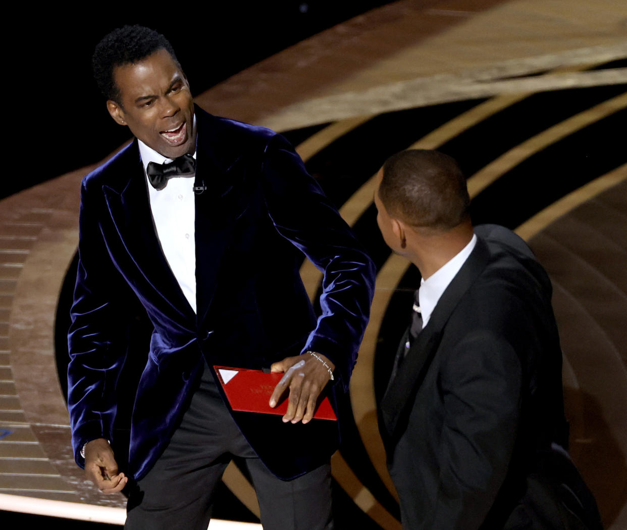 HOLLYWOOD, CALIFORNIA - MARCH 27: (L-R) Chris Rock and Will Smith are seen onstage during the 94th Annual Academy Awards at Dolby Theatre on March 27, 2022 in Hollywood, California. (Photo by Neilson Barnard/Getty Images)