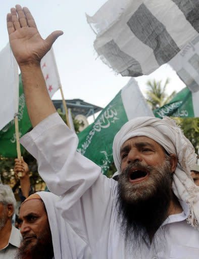 Pakistani demonstrators shout slogans during a protest rally against the anti-Islam film in Karachi. Pakistan distanced itself Sunday from a cabinet minister's bounty for killing the maker of "Innocence of Muslims", as protests against the movie continued from Turkey to Hong Kong