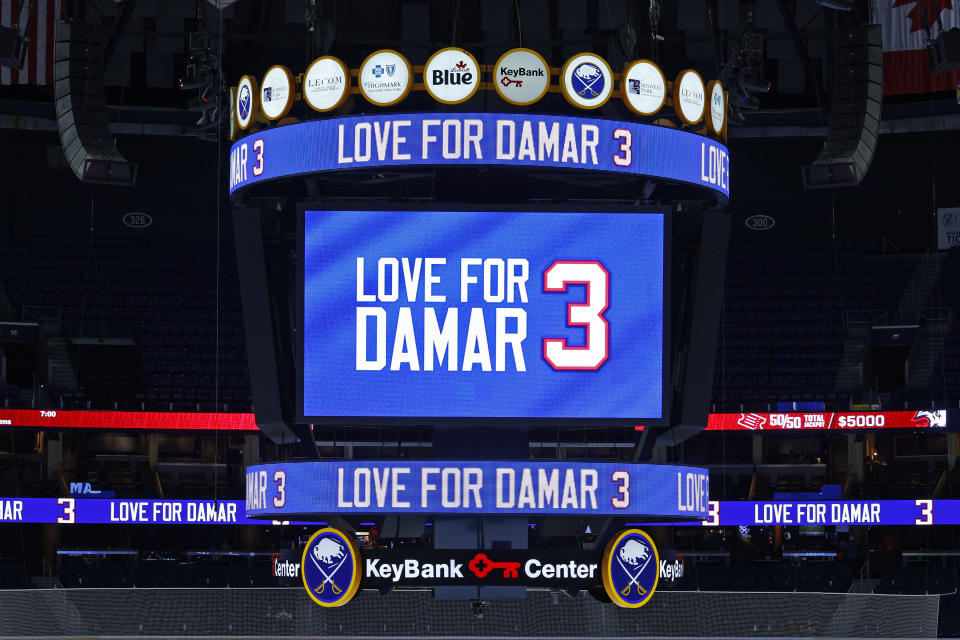 A message isdisplay on the jumbotron paying tribute to Buffalo Bills safety Damar Hamlin prior to an NHL hockey game between the Buffalo Sabres and the Minnesota Wild, Saturday, Jan. 7, 2023, in Buffalo, N.Y. (AP Photo/Jeffrey T. Barnes)