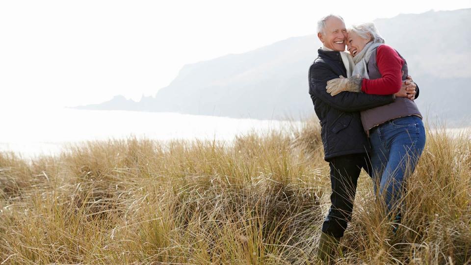 couple hugging by a lake