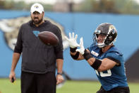 Jacksonville Jaguars tight end Tim Tebow, right, catches a pass during an NFL football practice, Monday, June 14, 2021, in Jacksonville, Fla. (AP Photo/John Raoux)