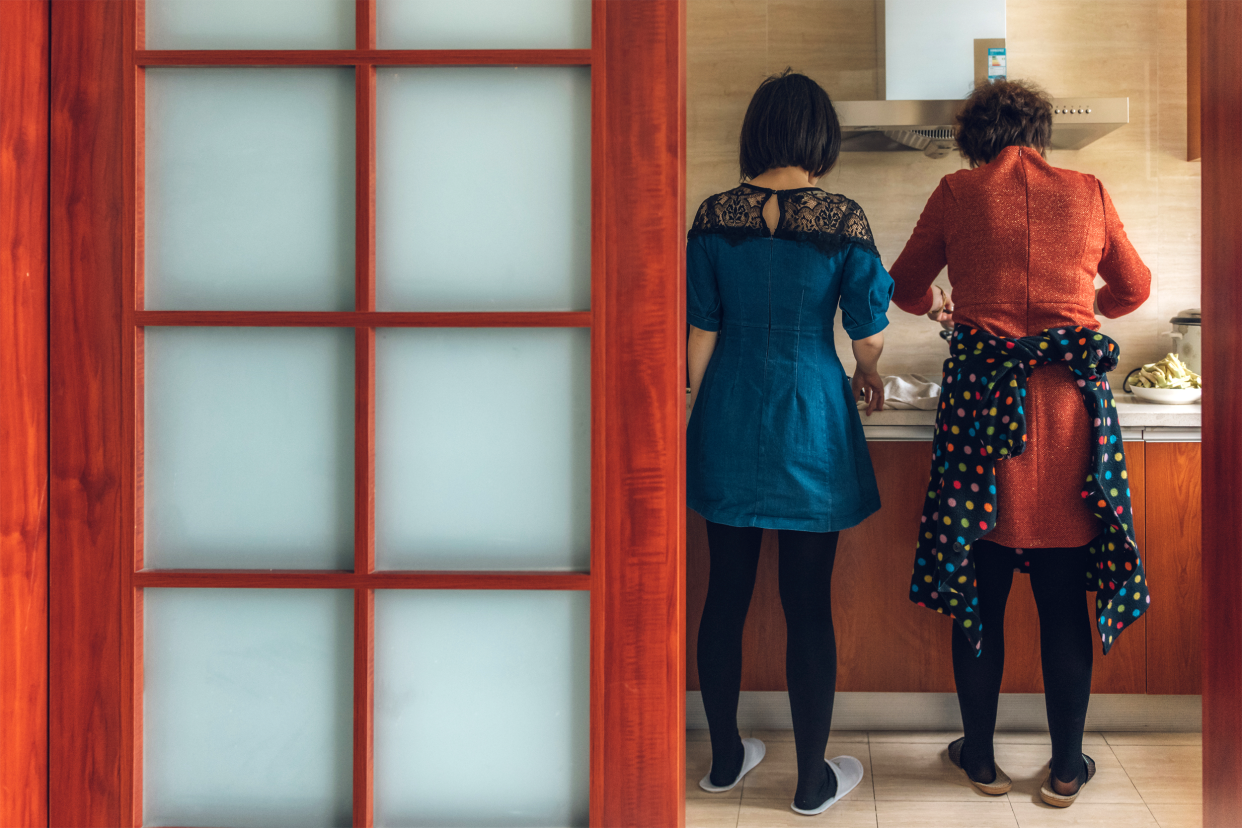 Mother and daughter cooking in kitchen