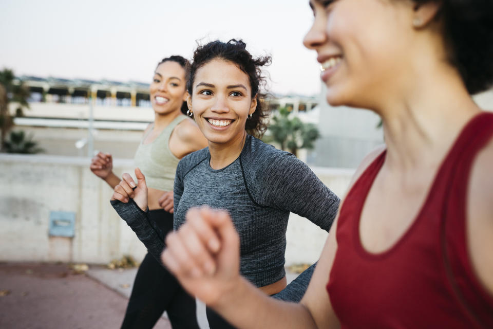 Three women running together.