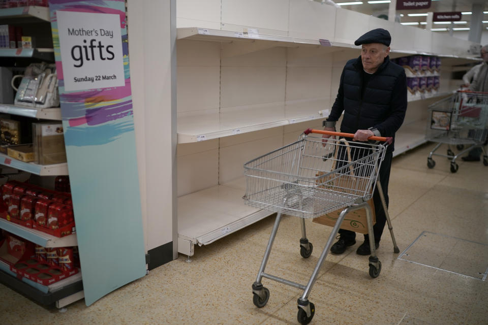 NORTHWICH, UNITED KINGDOM - MARCH 19: Senior citizens walk past empty shelves as they shop at Sainsbury's Supermarket on March 19, 2020 in Northwich, United Kingdom. A queue of approximately 600 old age pensioners formed before the market opened at 7am as the shop opened specially for the elderly. After spates of "panic buying" cleared supermarket shelves of items like toilet paper and cleaning products, stores across the UK have introduced limits on purchases during the COVID-19 pandemic. Some have also created special time slots for the elderly and other shoppers vulnerable to the new coronavirus. (Photo by Christopher Furlong/Getty Images)