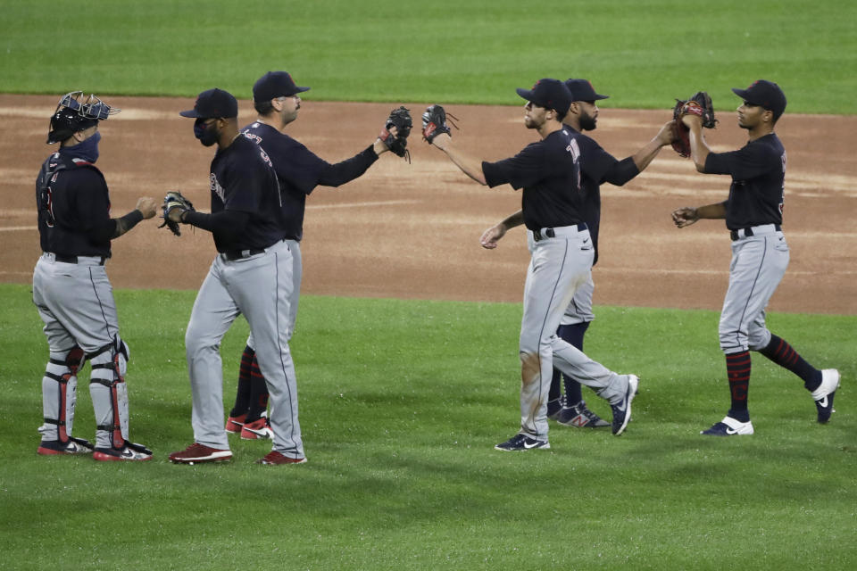 Cleveland Indians players celebrate after the Indians defeated the Chicago White Sox 5-4 in 10 innings in a baseball game in Chicago, Sunday, Aug. 9, 2020. (AP Photo/Nam Y. Huh)