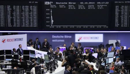 Visitors, attending the Frankfurt stock exchange for the first day of trading in Rocket Internet shares, stand in front of the DAX board October 2, 2014. REUTERS/Remote/Stringer