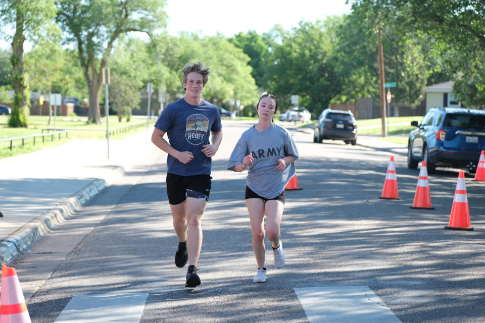 A pair of runners smile near the finish of the Chief Petty Officer Jack R. Barnes Run For the Fallen Saturday morning at Stephen F Austin Park in Amarillo.