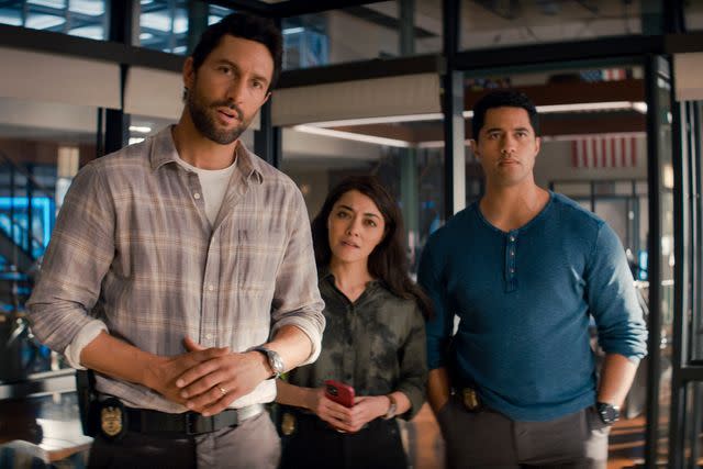 <p> CBS</p> Noah Mills as Jesse Boone, Yasmine Al-Bustami as Lucy Tara, and Alex Tarrant as Kai Holman in 'NCIS: Hawaii'.