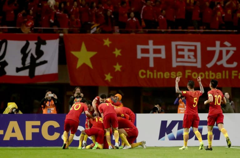 Chinese players celebrate after Yu Dabao scores during their World Cup football qualifying match against South Korea in Changsha, China on March 23, 2017